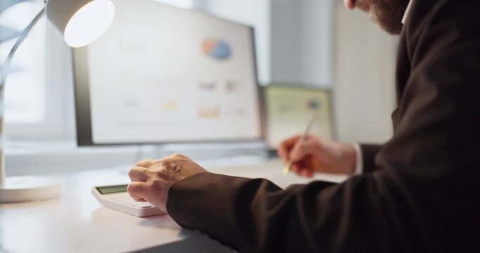 Man accountant in office using computer, reviewing finance. Hands use calculator and write notes by graphs and report on screen support business budgeting. Essential concept of financial audit.