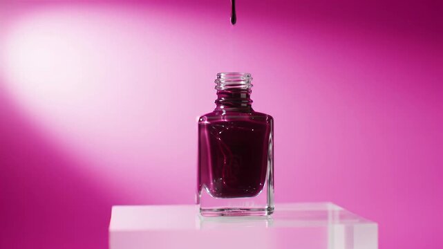 Extreme close-up video of burgundy nail polish dynamically rising and receding in a square glass bottle on a white plinth, fuchsia pink backdrop. Soft lighting, commercial beauty product advertising