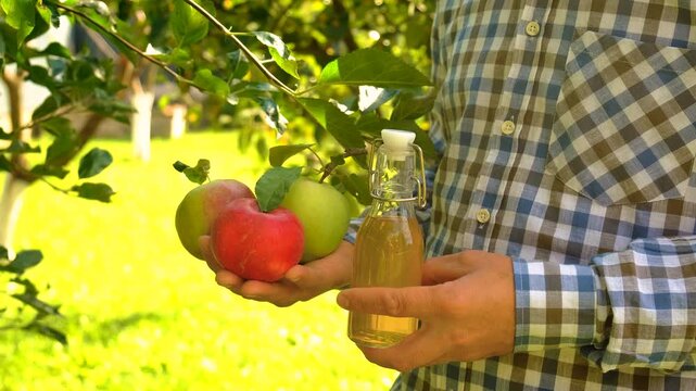 Apple cider vinegar against a background of apples. Selective focus.