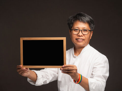 Business woman holding blank board with rainbow wristband