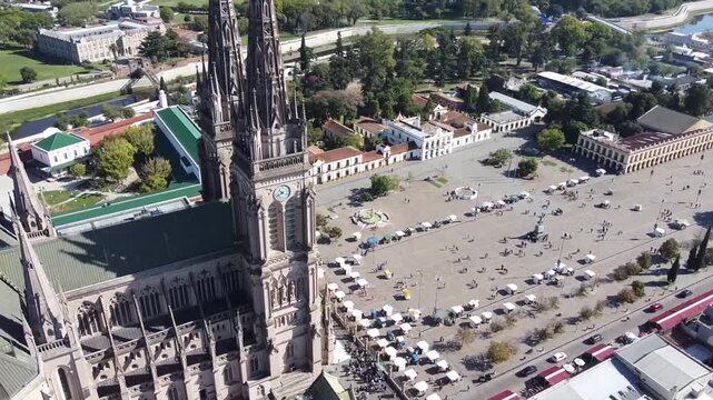 Full drone orbit showing the Basilica de Lujan, the central square, the Lujan river, museums and bridges in Buenos Aires, Argentina.