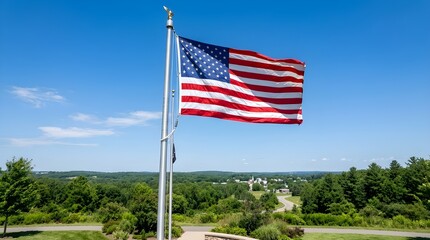 Fototapeta premium American flag waving on pole with blue sky landscape