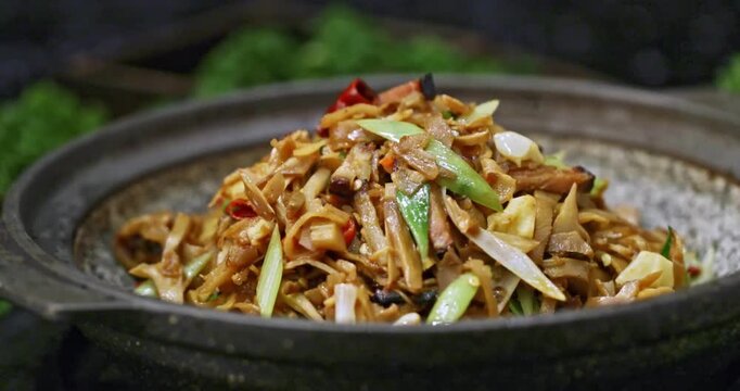Hunan local specialty dishes: Xiang casserole with garlic sprouts, spicy cured pork, and stir-fried bamboo shoots