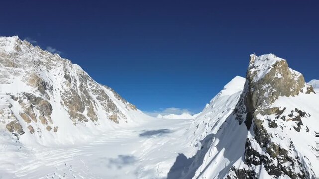 Slow panoramic view across a remote mountain glacier, showcasing rugged moraines, icy terrain, and dramatic peaks in one of the world&rsquo;s most extreme high-altitude environments