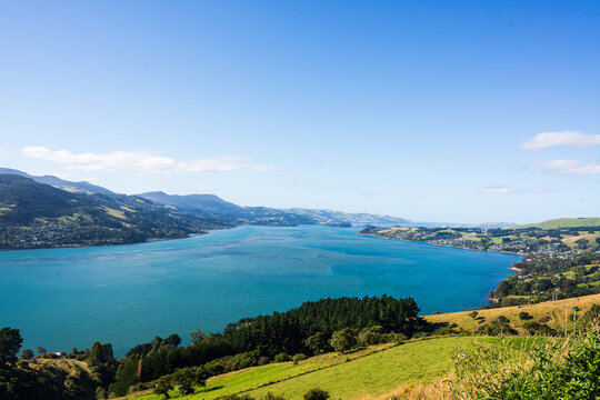 View of blue water inlet from a hill with mountains