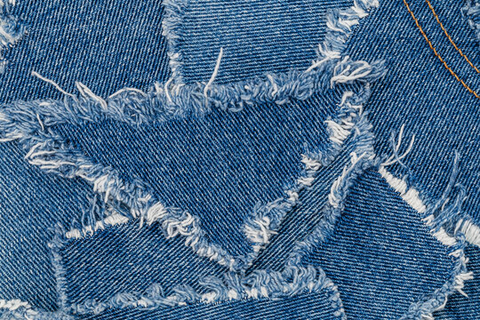 Denim fabric with star-shaped patches sewn together at a crafting session on a sunny afternoon