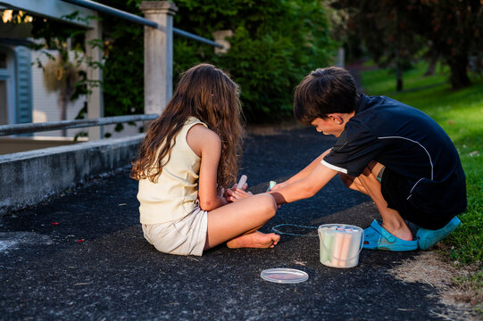 Children drawing with sidewalk chalk