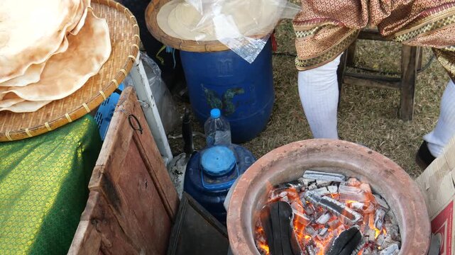 Grilling traditional Thai rice cracker