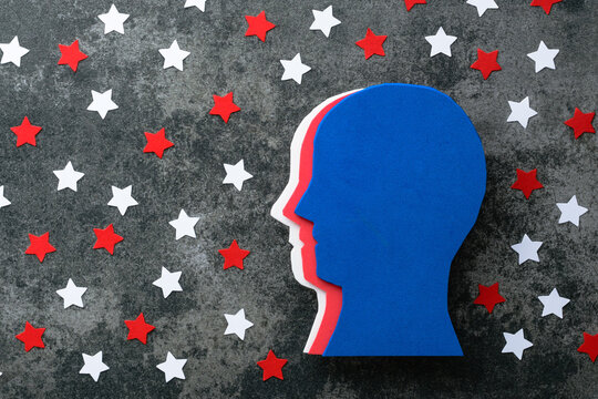 Creative concept of a silhouette human head with a brain and decorated with a stars pattern on a gray background. Creative concept of American patriotism, July 4th celebration. top view