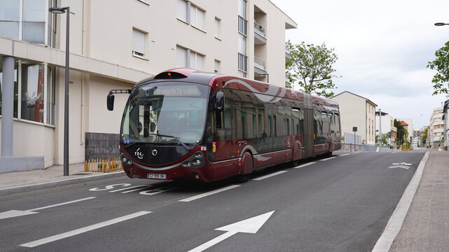 CLERMONT-FERRAND, FRANCE - APRIL 28, 2026: T2C bus driving uphill past modern apartments