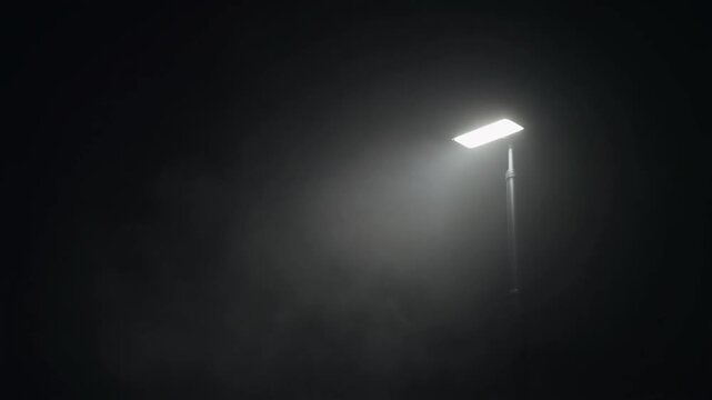 Bright Urban Street Light Piercing Through Dense Fog on a Mysterious Dark Night