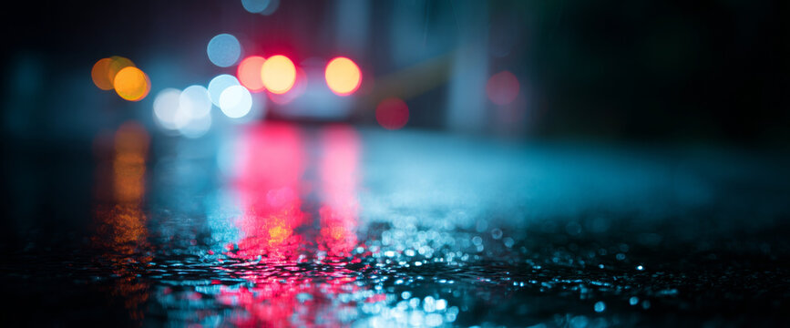 Wet street with colorful blurred lights