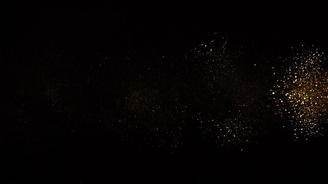 Scattered golden particles emerging from darkness abstract minimal luxury background with soft glowing dust clusters elegant cinematic composition and atmospheric depth