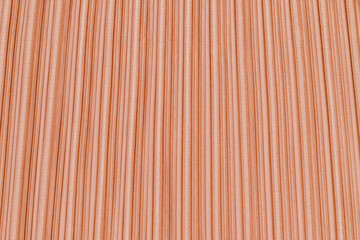 Fototapeta premium Texture of fabric with vertical lines in light coral color displayed on a flat surface during daylight
