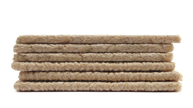 Wholemeal crispy rye bread pile, isolated on white background, side view