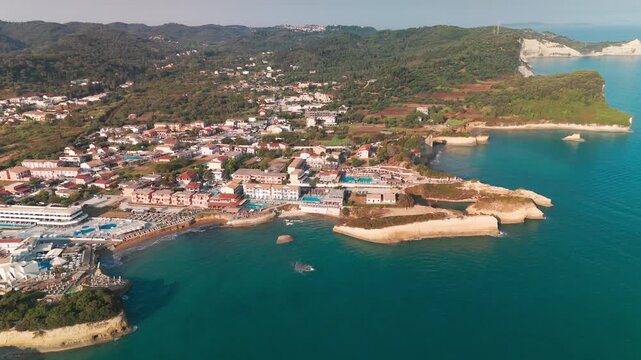 Aerial Drone Panning View of Sidari Settlement and Vast Turquoise Ionian Sea in Corfu Greece