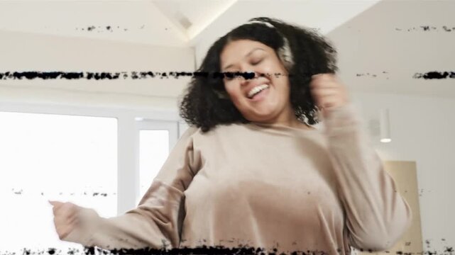 Signal glitch revealing woman dancing by couch headphones sending music waves, camera cutting close
