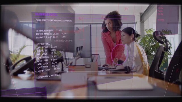 Lead woman tapping tablet and pointing screen, seated analyst updating Qtr metrics with AR overlay