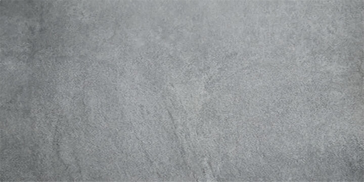 A close-up view of a textured gray stone surface, showcasing subtle variations in color and natural patterns.