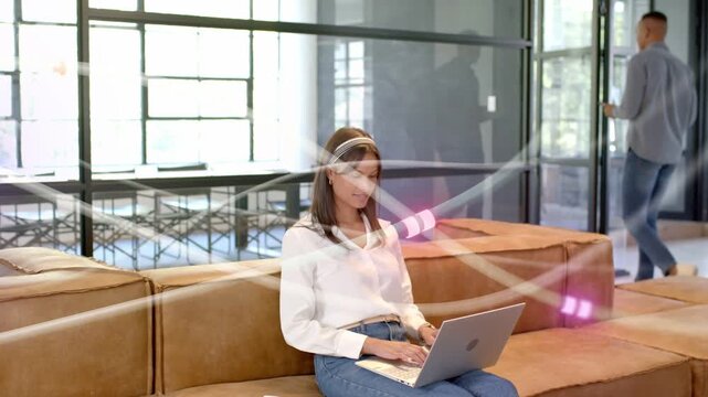 Pink streaks sweeping, woman typing laptop editing doc in coworking, man walking checking phone