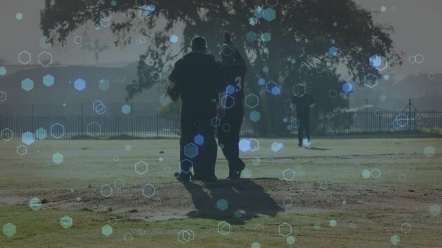 Coach and player walking toward camera on sports field after practice, hex overlay obscuring glove