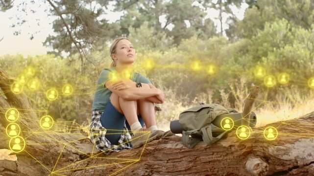 Hiker sitting on log watching appearing glowing nodes forming around head and pack, mapping tech