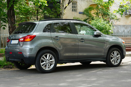 Bucharest, Romania &ndash; April 28, 2026: Closeup side back view of Mitsubishi ASX ClearTec SUV gray car parked on street