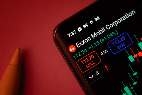 Dhaka, Bangladesh- 08 Sep 2025: Close-up of a phone screen showing Exxon Mobil Corporation stock market data with a candlestick chart.