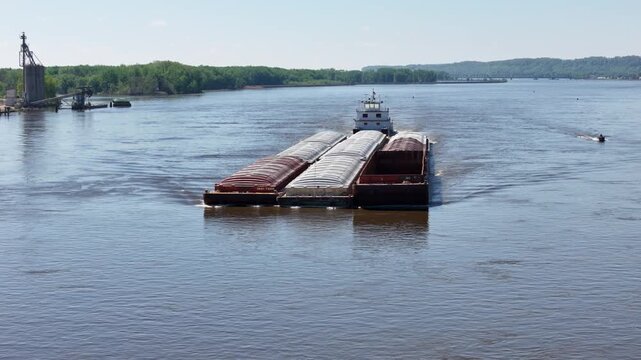 Tug boat pushing a large set of barges North up  the Mississippi River