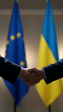 concept of an official handshake between representatives of ukraine and the european union against the background of state flags, reflecting the process of integration and support