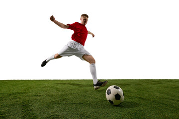 Obraz premium Soccer player jumping to strike ball on grass field against white background. Concept of football action, training promo, sports event banner, athlete campaign and tournament advertising.