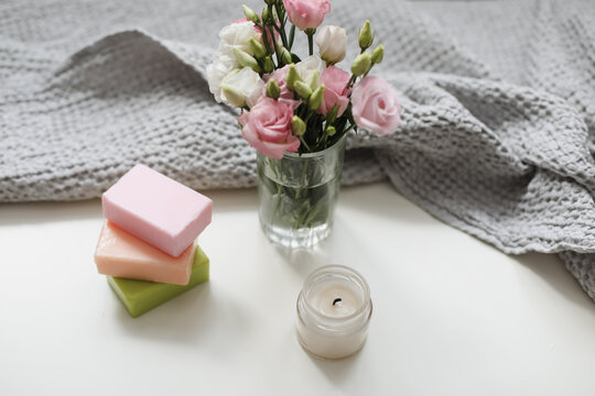 top view of natural decorated homemade soap with flowers on white surface. spa organic soap. Natural vegan soap with rose fragrance