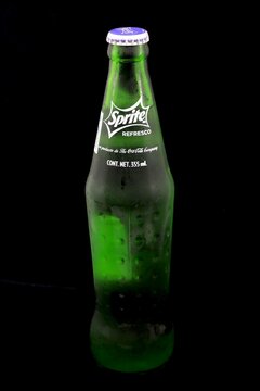 Sprite soda bottle on a black background