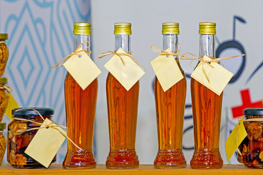 Healthy apple cider vinegar drink inside glass bottles sold on local market stall