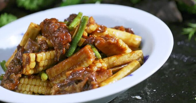 Braised pork ribs with corn, green beans, and tofu puffs - a Northeastern-style stew