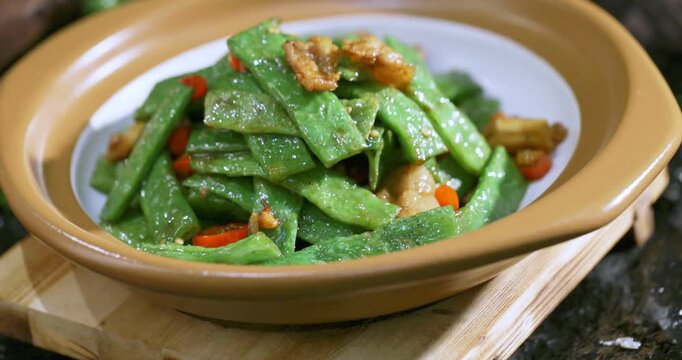 Stir-fried pork belly with garlic, chili peppers, and red beans in soy sauce