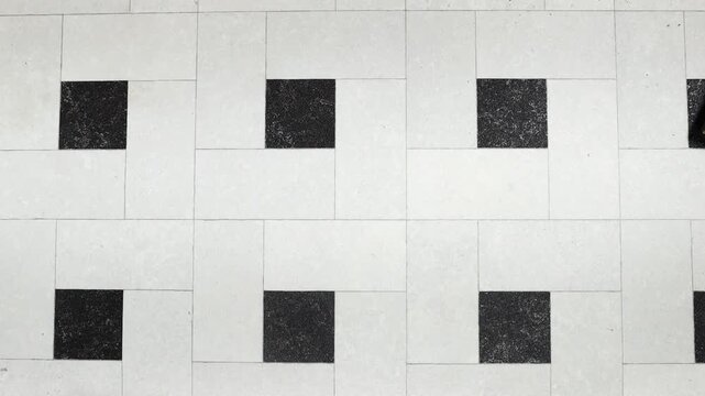 Person holding white empty paper A4 on tiles backdrop