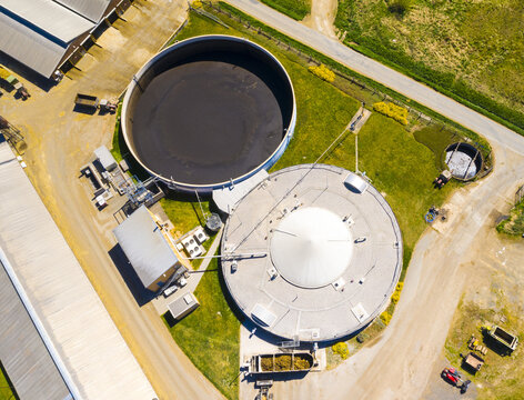 Biogas plant and farm in fields. Renewable energy from biomass. Aerial view to Czech industry. Sustainable development in European Union.	
