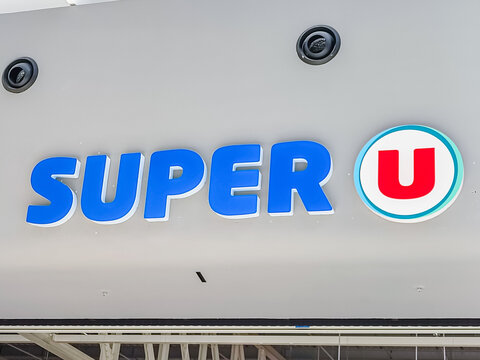 Le Mans, France - April 24, 2026: Super U supermarket sign displayed prominently on building exterior, featuring blue letters and circular logo