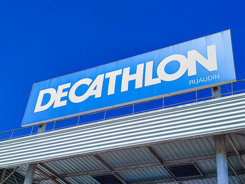 Le Mans, France - April 24, 2026: Decathlon store sign with blue background and white lettering, visible from below against clear sky