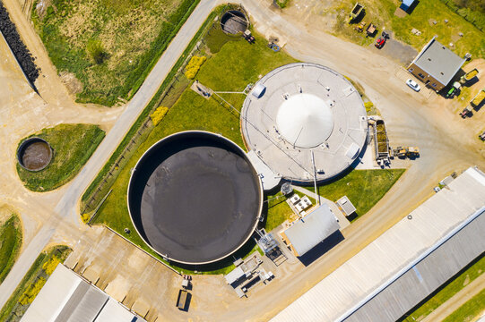 Biogas plant and farm in fields. Renewable energy from biomass. Aerial view to Czech industry. Sustainable development in European Union.	
