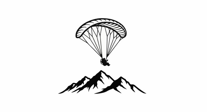 Silhouette of a paraglider above a mountain range