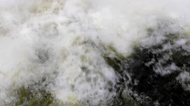 Turbulent White Water Rapids Splashing and Churning in Close-Up Motion Footage