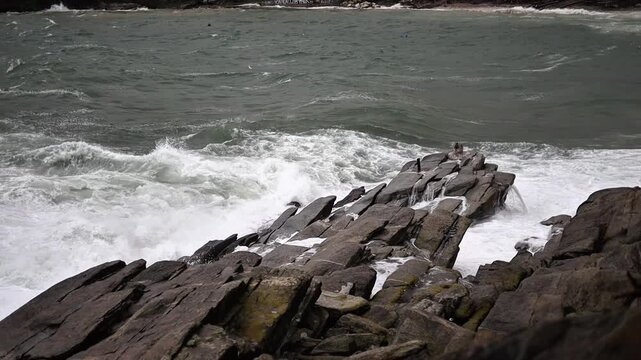 Stormy Harbor View in Kavala Greece Waves Crashing on Rocks