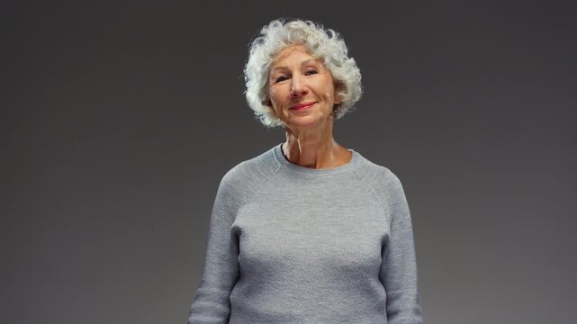 Old female hand holds in fingers capsule of Omega 3. Senior elderly woman eat yellow pill, use. Grandmother take fish oil capsule or medicine and puts it in mouth. Dietary supplements in nutrition