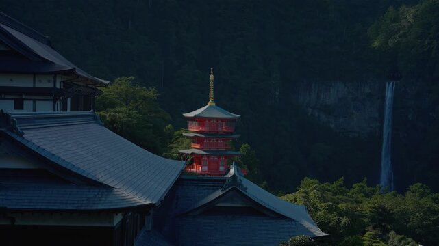 Three-story pagoda of Seiganto-ji Temple seen over shrine rooftops at Kumano Nachi Taisha in Wakayama, Japan