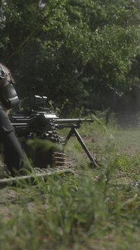 Female soldier firing heavy PKM machine gun at shooting range
