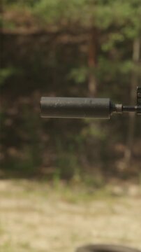 Soldier firing rifle with suppressor focusing on muzzle sound suppression