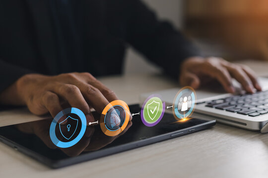 User accessing tablet with multi factor authentication icons including fingerprint, shield and user verification, representing cybersecurity, secure access and identity protection in digital business.