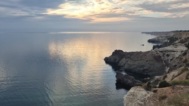Cliffs ocean sunset over dramatic sea landscape and tall rock formations during golden hour travel view
